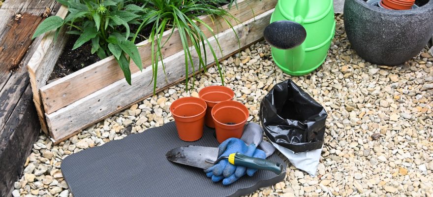 a-garden-with-pots-and-gardening-tools-on-the-ground