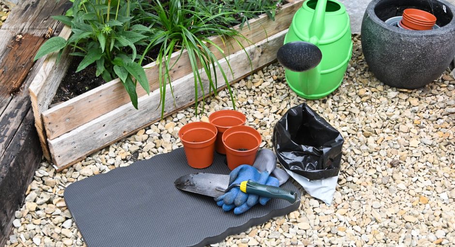 a-garden-with-pots-and-gardening-tools-on-the-ground